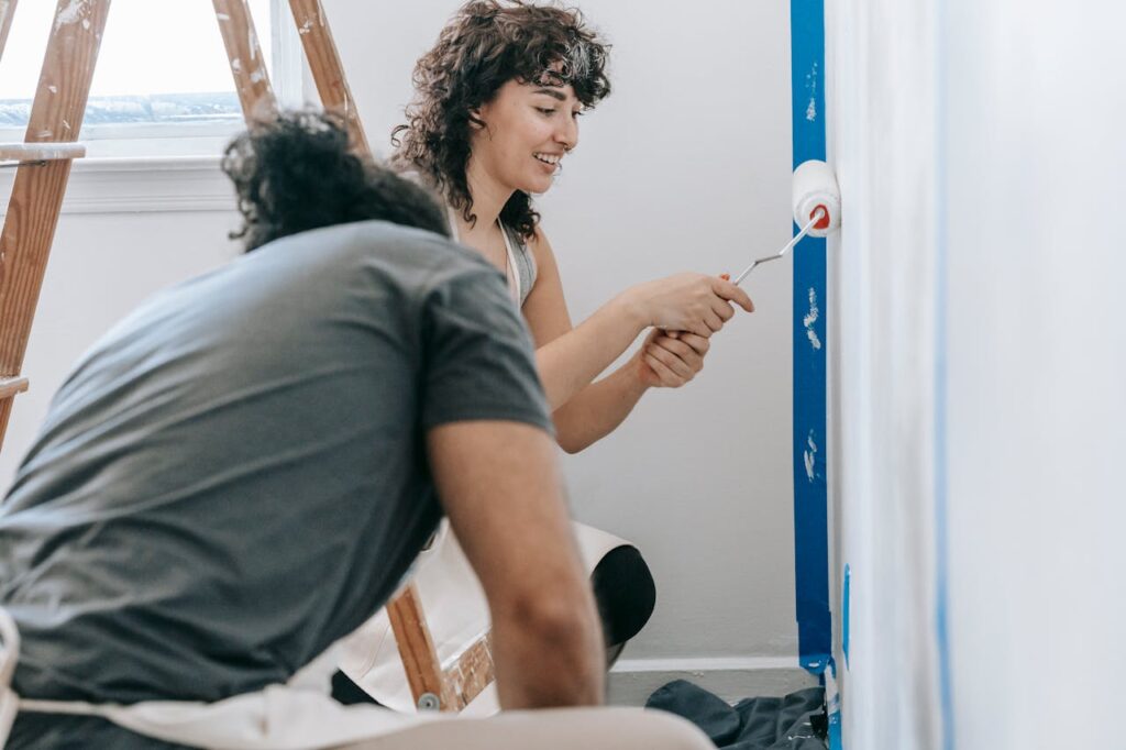 Woman Painting The Wall